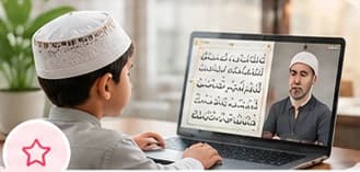 A child seated at a low desk, memorising from the Quran.